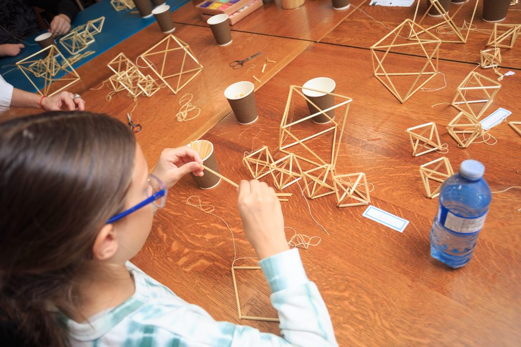 Creative Inclusion participants making traditional straw decorations